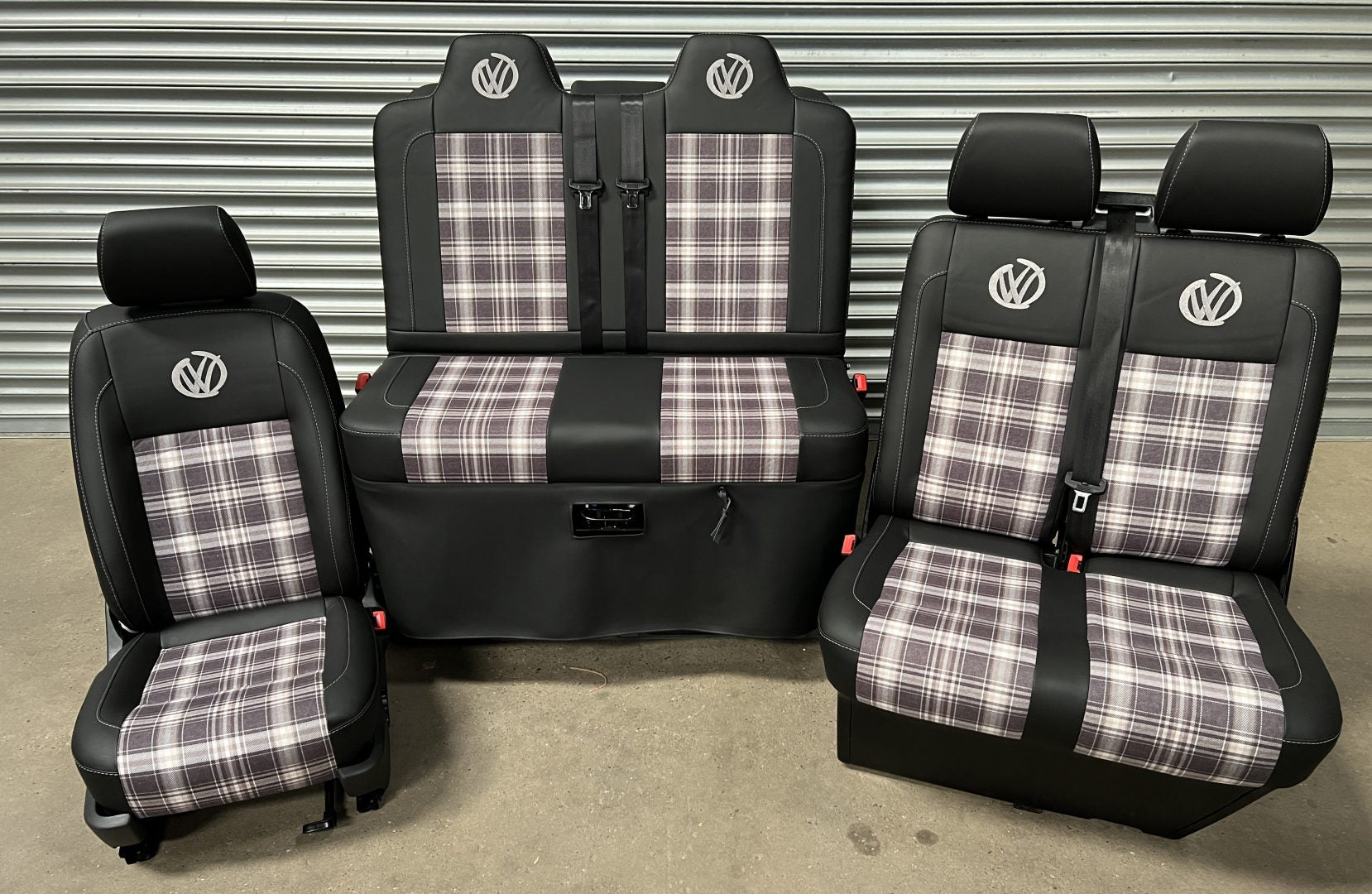Rock and roll bed VW T5 T6 + Front seats 2+1 in Black leatherette, with upgraded tartan fabric centre panels and graffiti VW logos in grey.