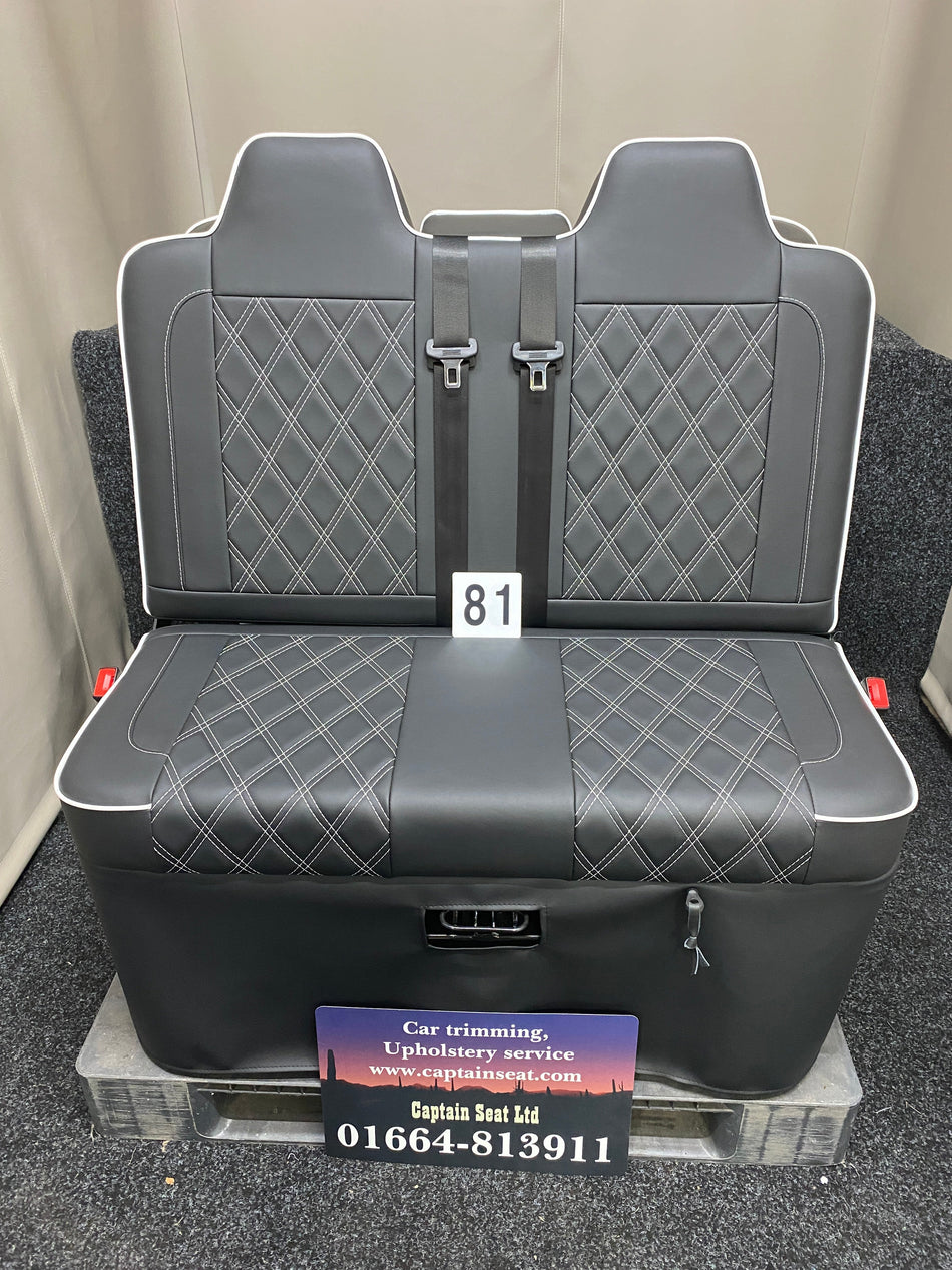 Rock & Roll Bed 3/4 M1 Tested 2 Seater, front view of black leatherette seat with white piping, white Bentley stitching and integrated seatbelts. 