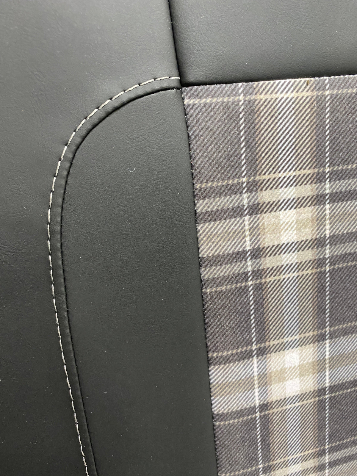 Rock & Roll Bed 3/4 M1 Tested 2 Seater, close-up of tartan centre panel and grey-stitched black leatherette edge detail.