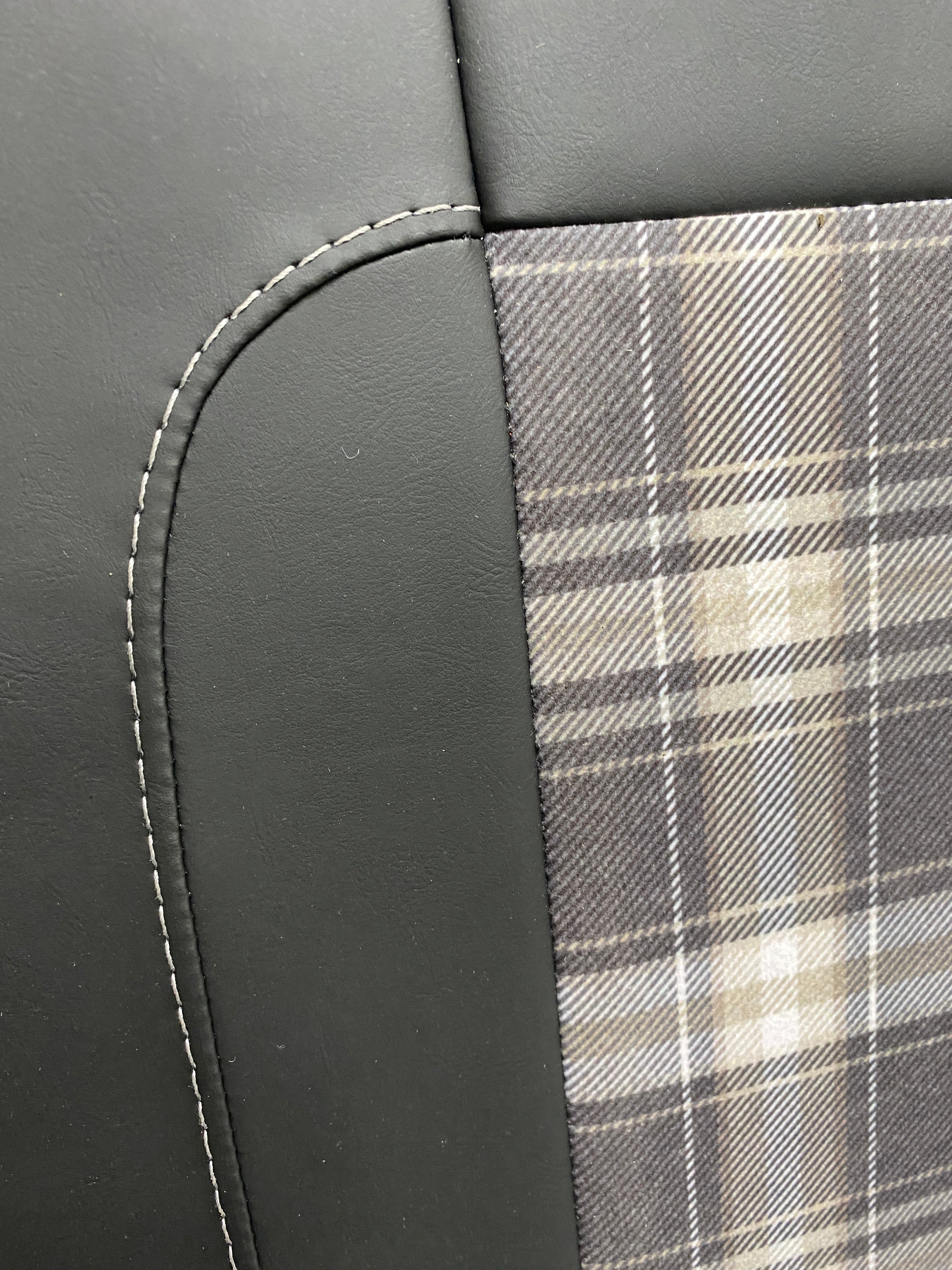 Rock & Roll Bed 3/4 M1 Tested 2 Seater, close-up of tartan centre panel and grey-stitched black leatherette edge detail.