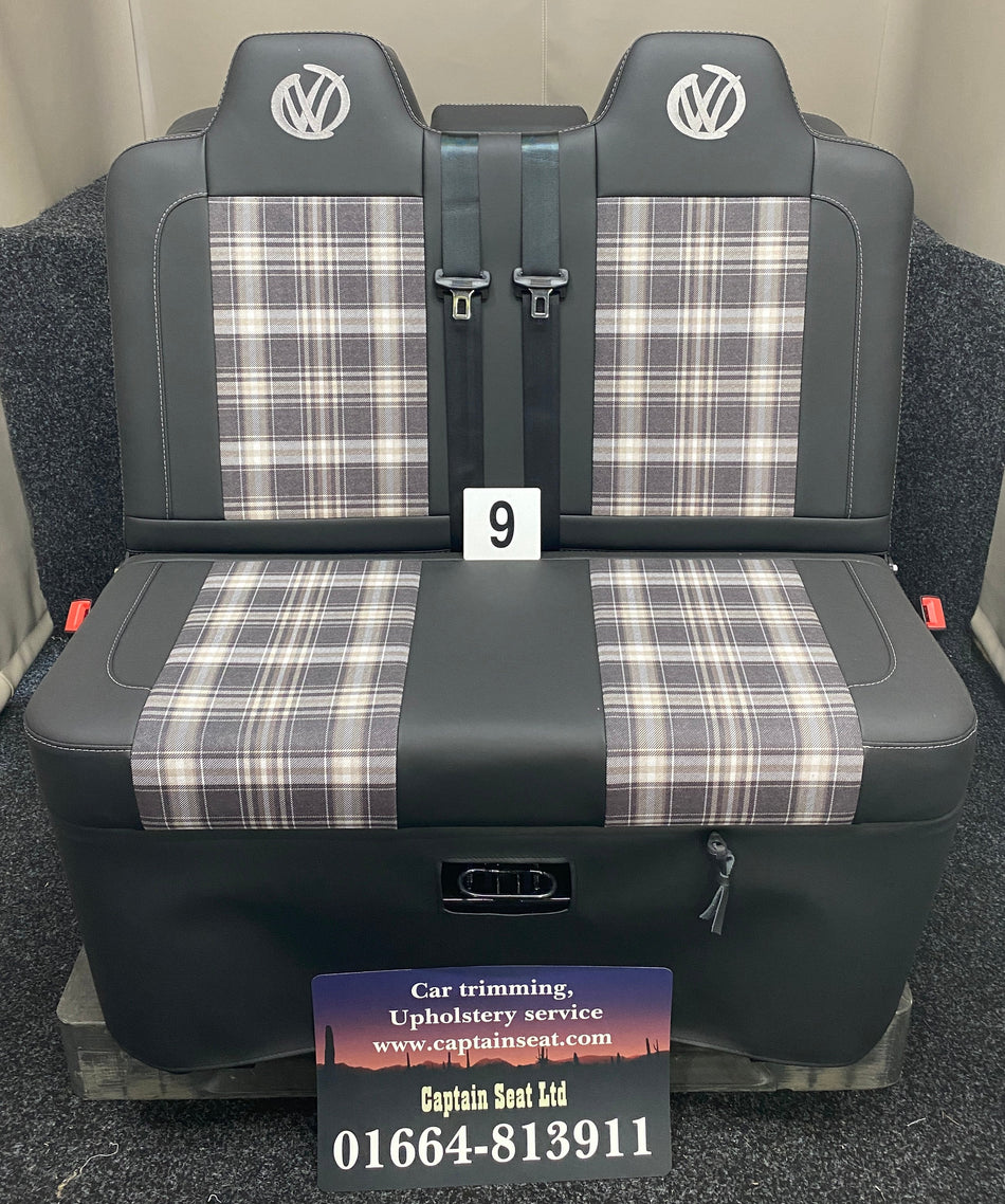 Rock & Roll Bed 3/4 M1 Tested 2 Seater, front view of black leatherette seat with tartan centre panels, grey stitching, and graffiti-style VW logos.