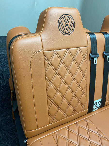 Rock & Roll Bed 3/4 M1 Tested 2 Seater – Gas Assisted Legged, side angle close-up of brown leatherette backrest with brown stitching and VW logo.