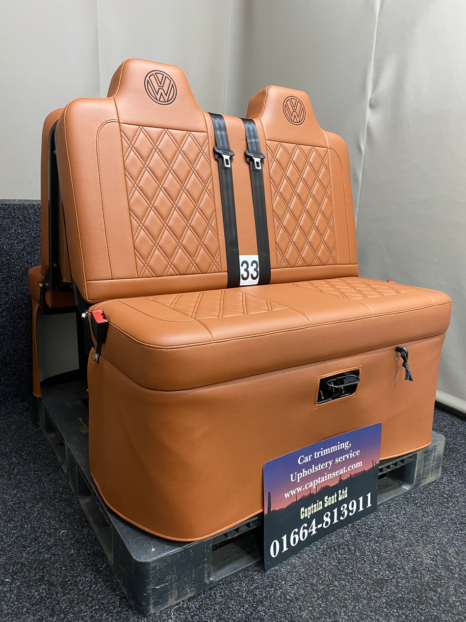 Rock & Roll Bed 3/4 M1 Tested 2 Seater – Gas Assisted Legged, angled side view of brown leatherette seat with brown stitching, seatbelts and VW logos.