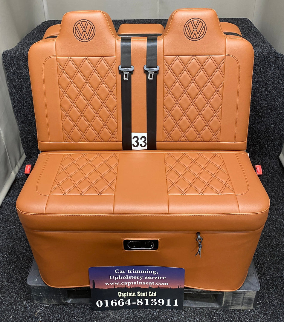 Rock & Roll Bed 3/4 M1 Tested 2 Seater – Gas Assisted Legged, front view of brown leatherette seat with matching Bentley stitching and brown VW logos.