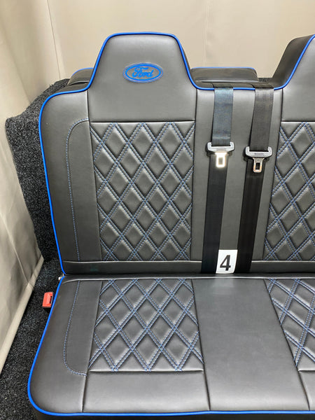 Rock & Roll Bed 3/4 M1 Tested 2 Seater – Gas Assisted Legged, close-up of one seat section with blue Bentley stitching, blue piping, integrated seatbelts and Ford logo.