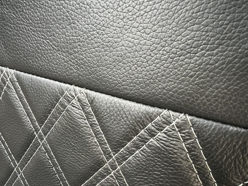 Rock & Roll Bed 3/4 width M1 Tested Legged, close-up of the black real leather with grey stitching.