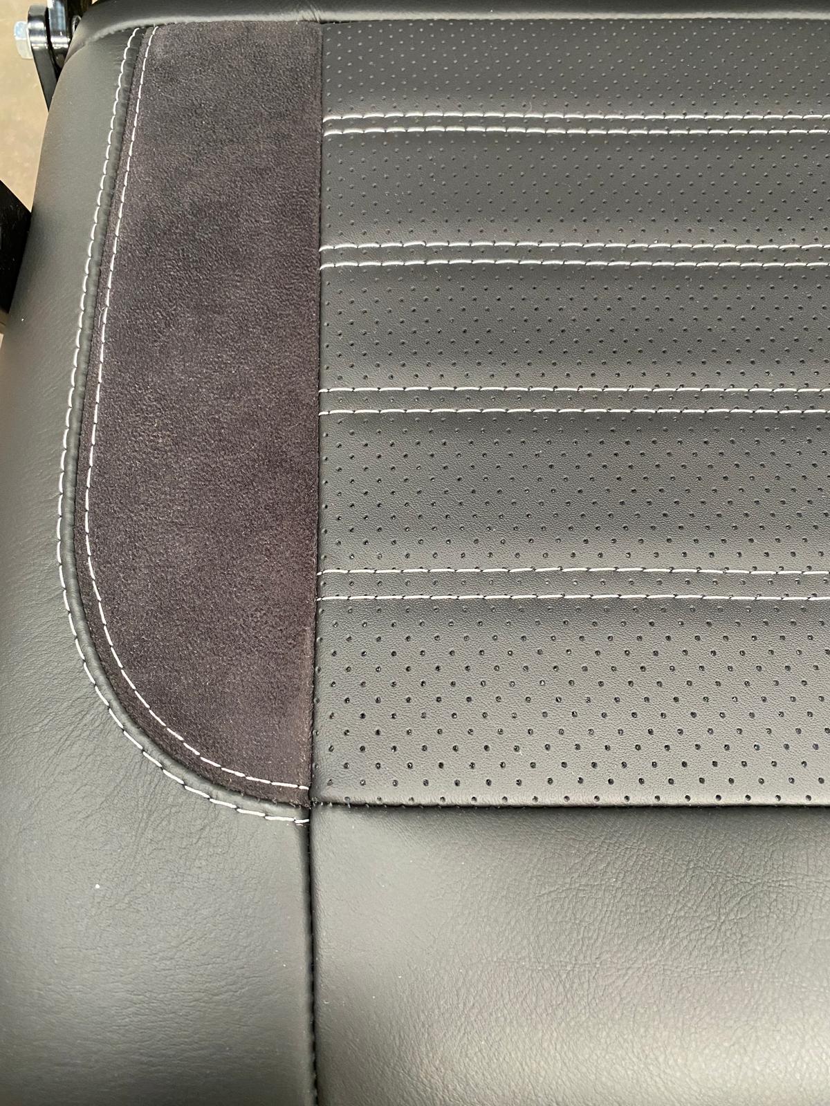 Rock & Roll Bed Full Size M1 tested Legless Gas Assisted close-up of seat base with perforated leather centre panel, black Alcantara insert, and light grey stitching.