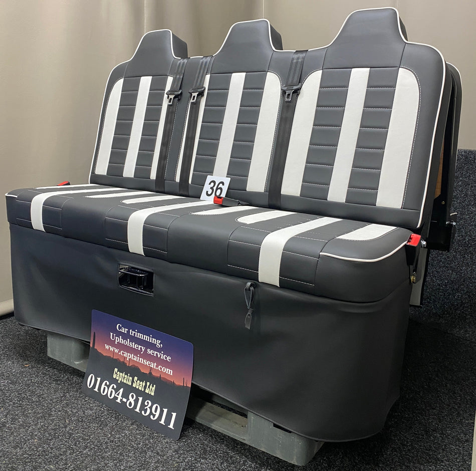Rock & Roll Bed M1 Tested Full Width Gas Assisted, side-angled view in black leatherette with white centre panels, white piping, and white stitching.