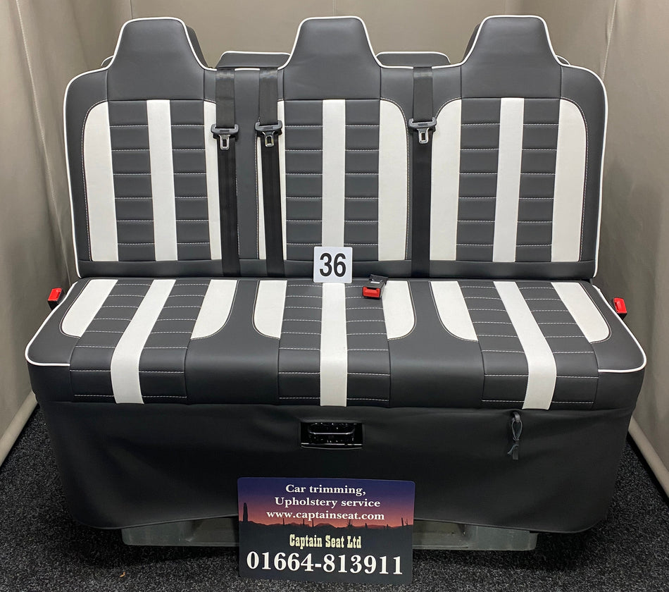 Rock & Roll Bed M1 Tested Full Width Gas Assisted, front view in black leatherette with white vertical panels, white piping, and white stitching.
