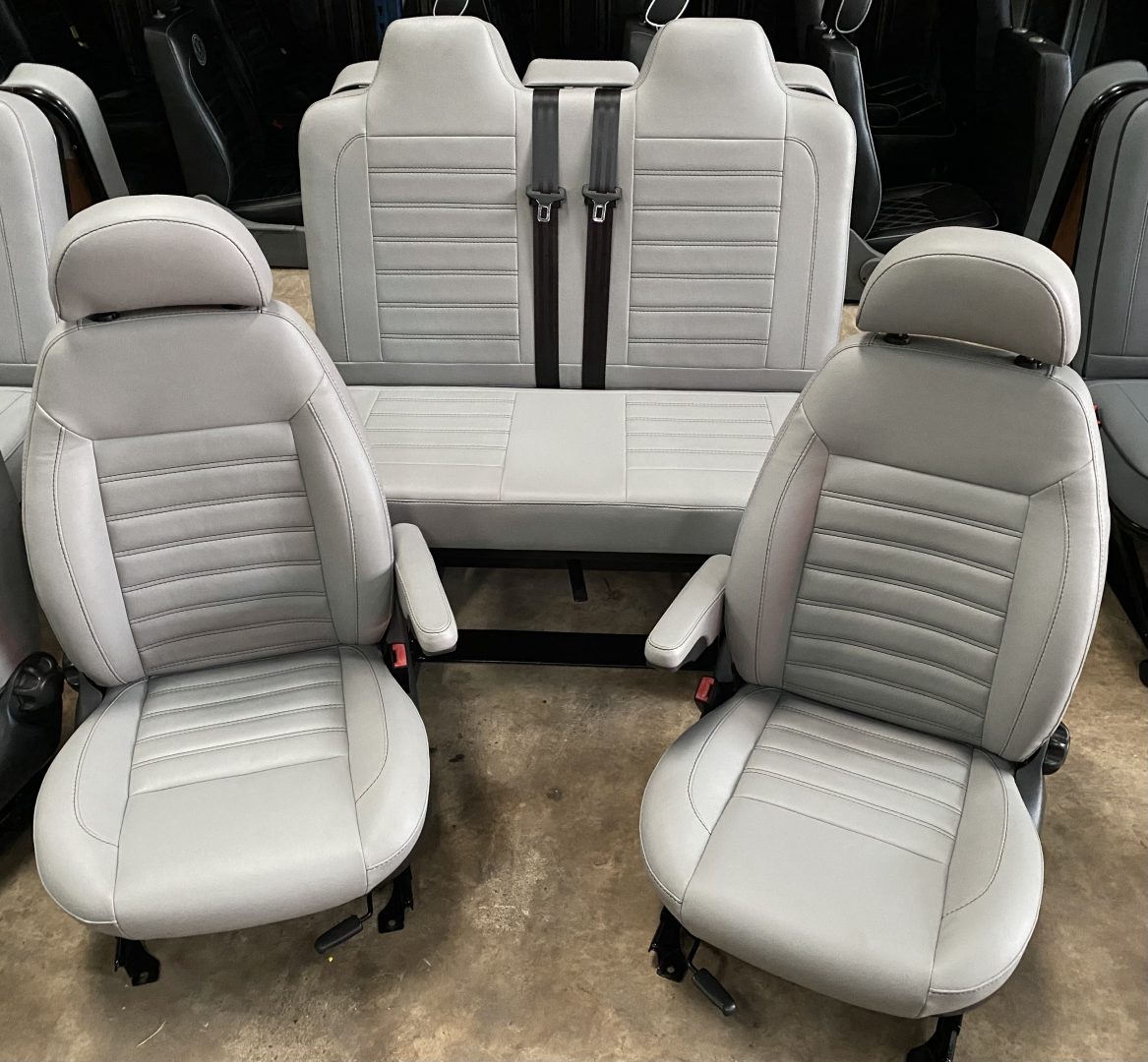 Rock & roll bed M1 tested legged and single swivel captain seats in grey leatherette with horizontal stitching.