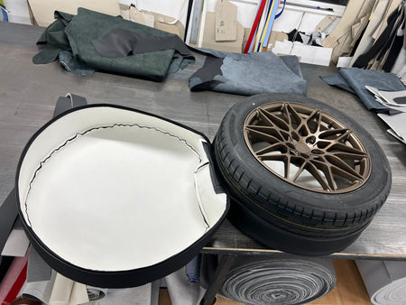 Spare Wheel Cover shown open with a wheel placed inside.