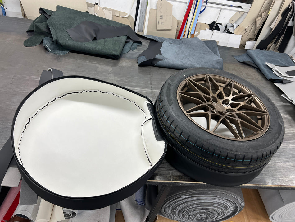 Spare Wheel Cover shown open with a wheel placed inside.