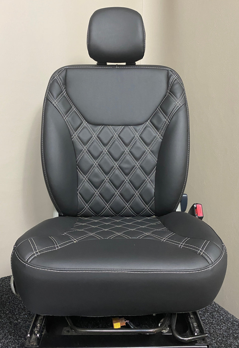TVP Trafic Vivaro Primastar driver seat in black leatherette upholstery with white Bentley stitching and matching black centre panel.