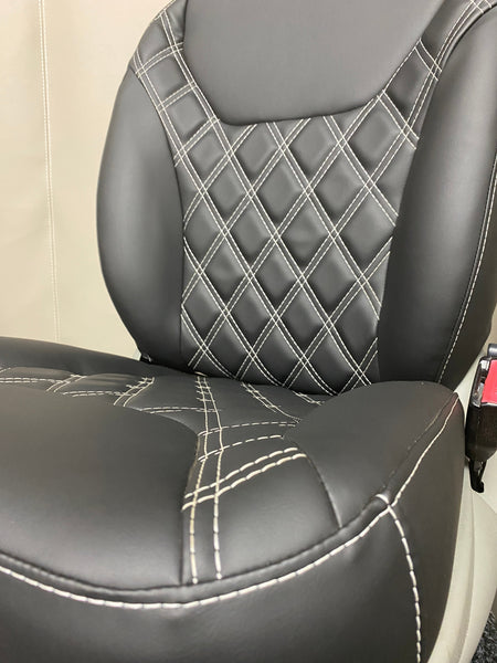 TVP Trafic Vivaro Primastar front seat in black leatherette with white Bentley stitching, angled close-up showing the centre panel and the seat base.