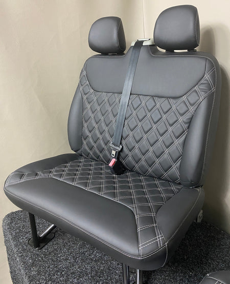 TVP Trafic Vivaro Primastar double seat in black leatherette with white Bentley stitching, shown at an angled view.