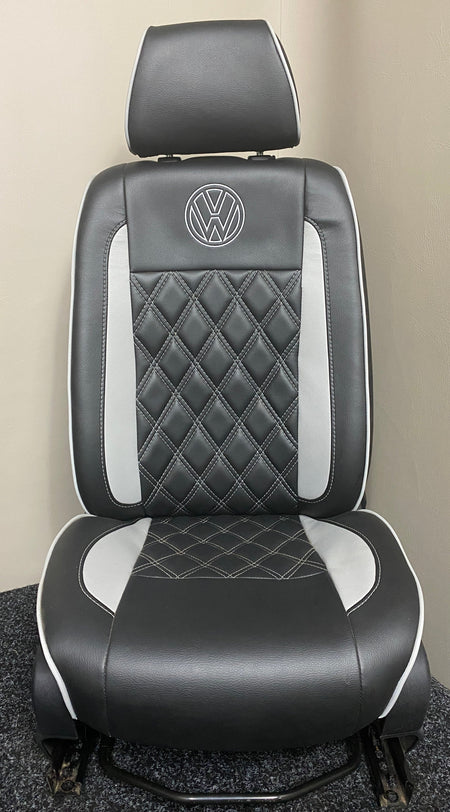 Volkswagen Crafter driver seat in black leatherette with grey inserts, light grey Bentley stitching and white VW logo.