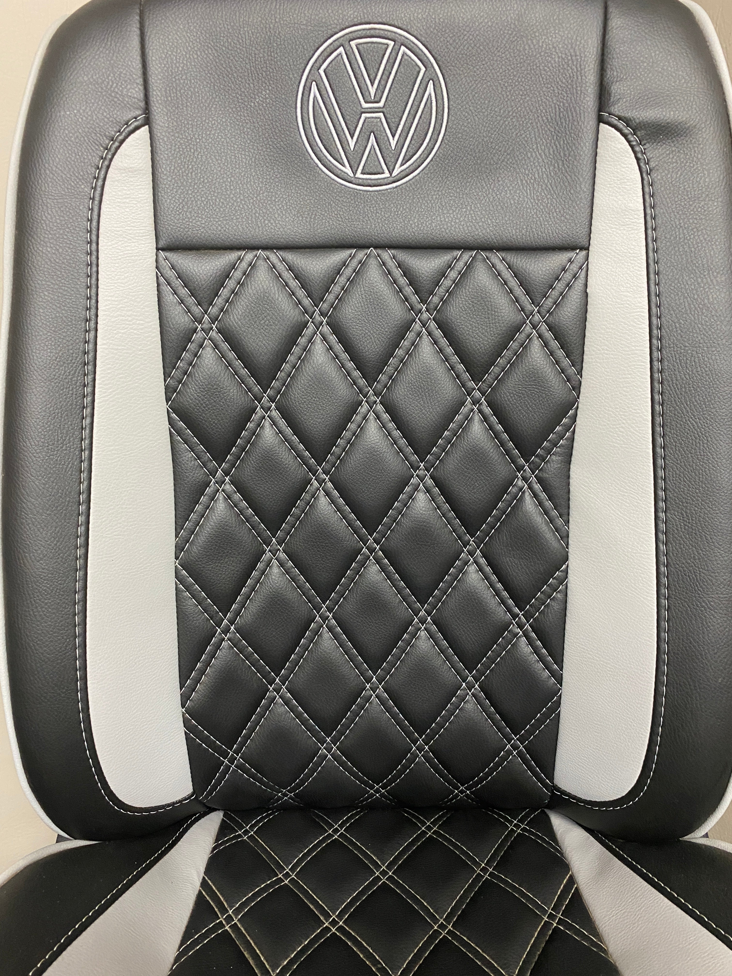 Volkswagen Crafter Front Seat close-up of the backrest showcasing light grey Bentley stitching and grey inserts on black leatherette.