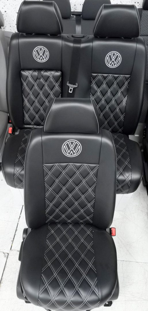 VW Crafter Front Seats in black leatherette upholstery with white Bentley stitching and VW logos.