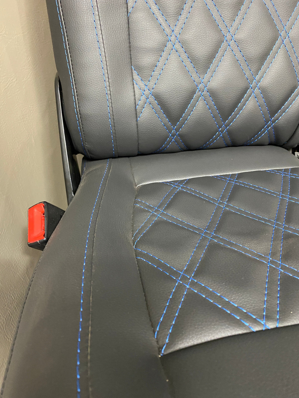 VW Factory Front T5 T6 Seat angled close-up, showing blue Bentley cross stitching detail across the seat base and backrest.