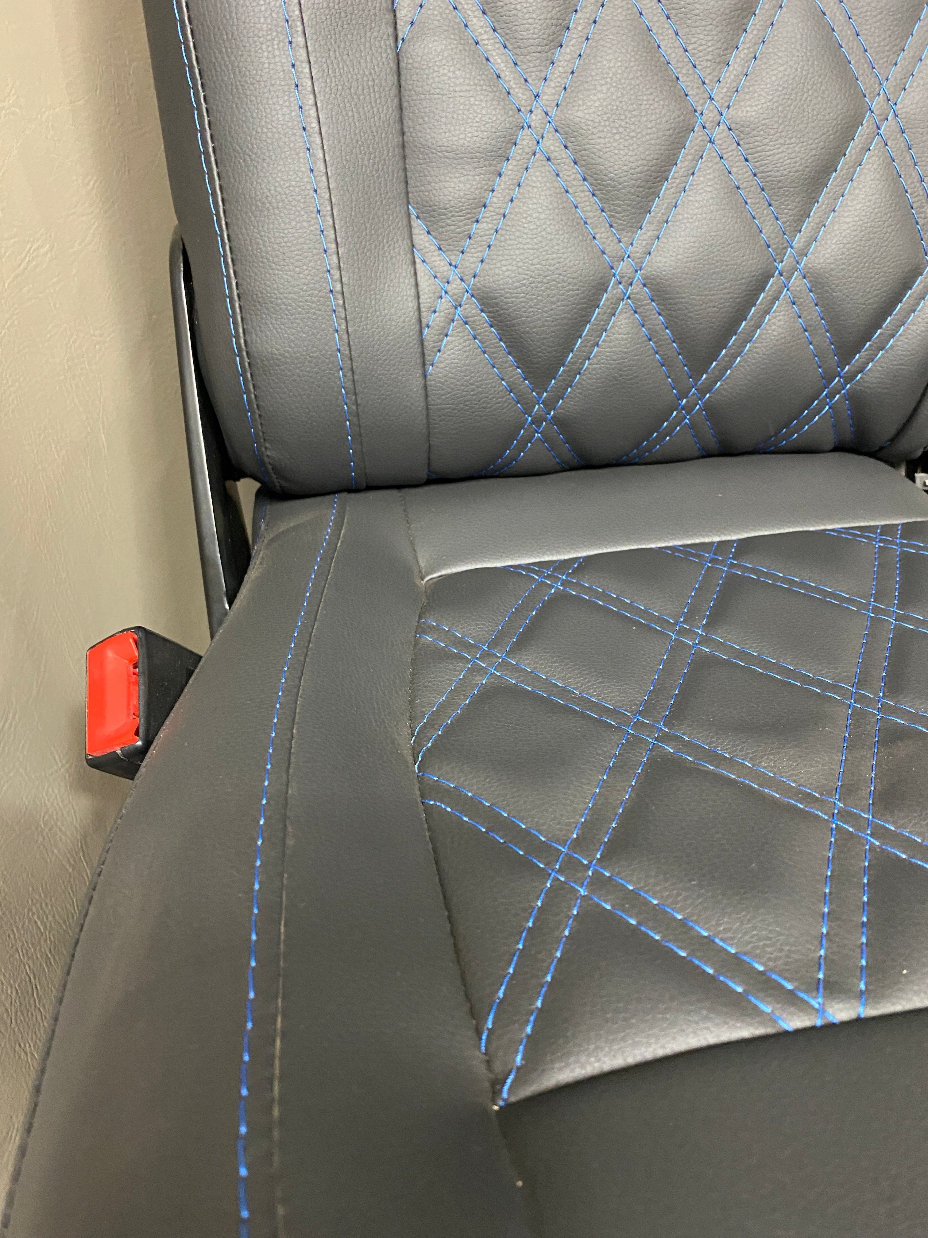 VW Factory Front T5 T6 Seat angled close-up, showing blue Bentley cross stitching detail across the seat base and backrest.