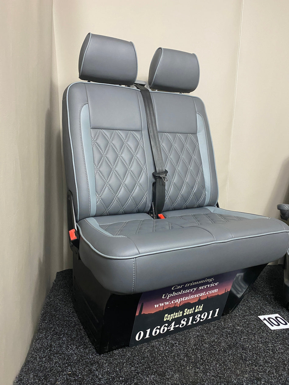VW Factory Passenger Seats T5 T6, angled view of medium grey leatherette double seat with light grey inserts and white Bentley cross stitching.