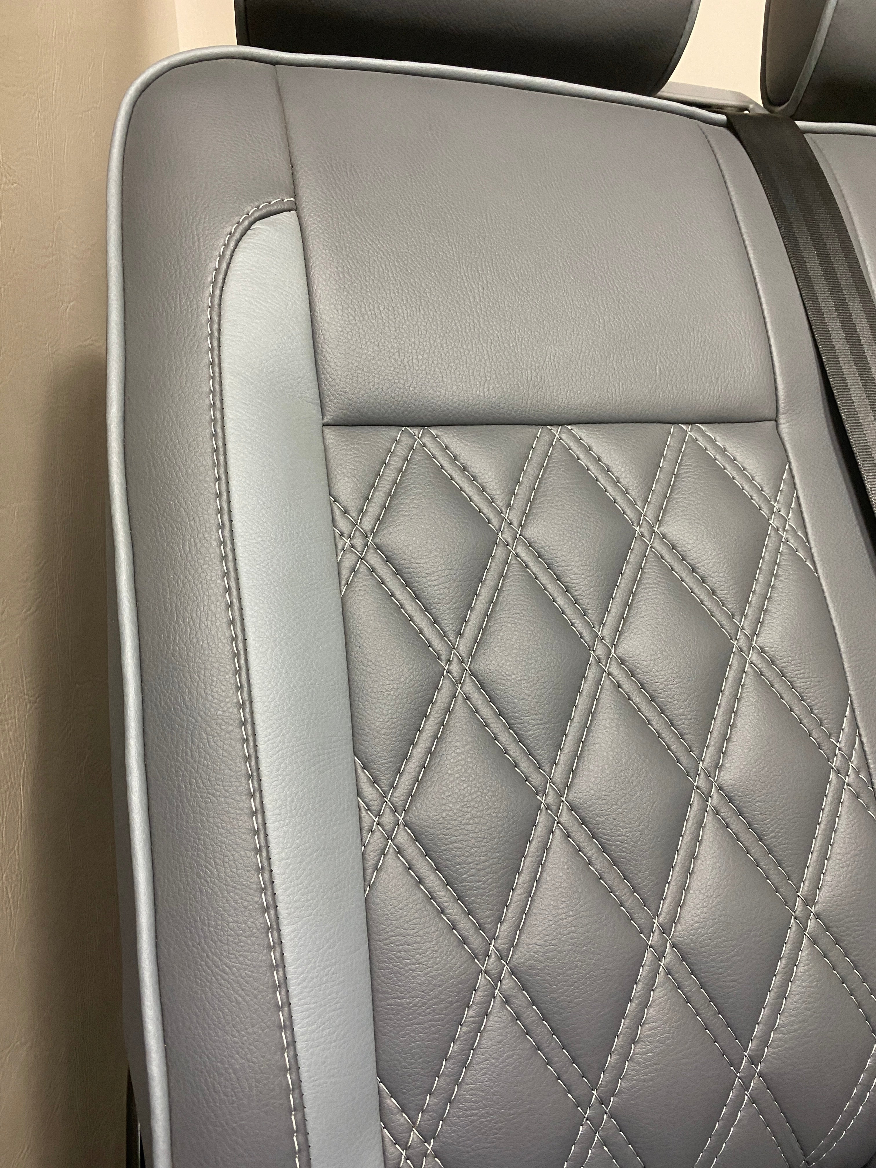 VW Factory Front Seats T5 T6, close-up of seat back with light grey leatherette insert and white Bentley cross stitching.