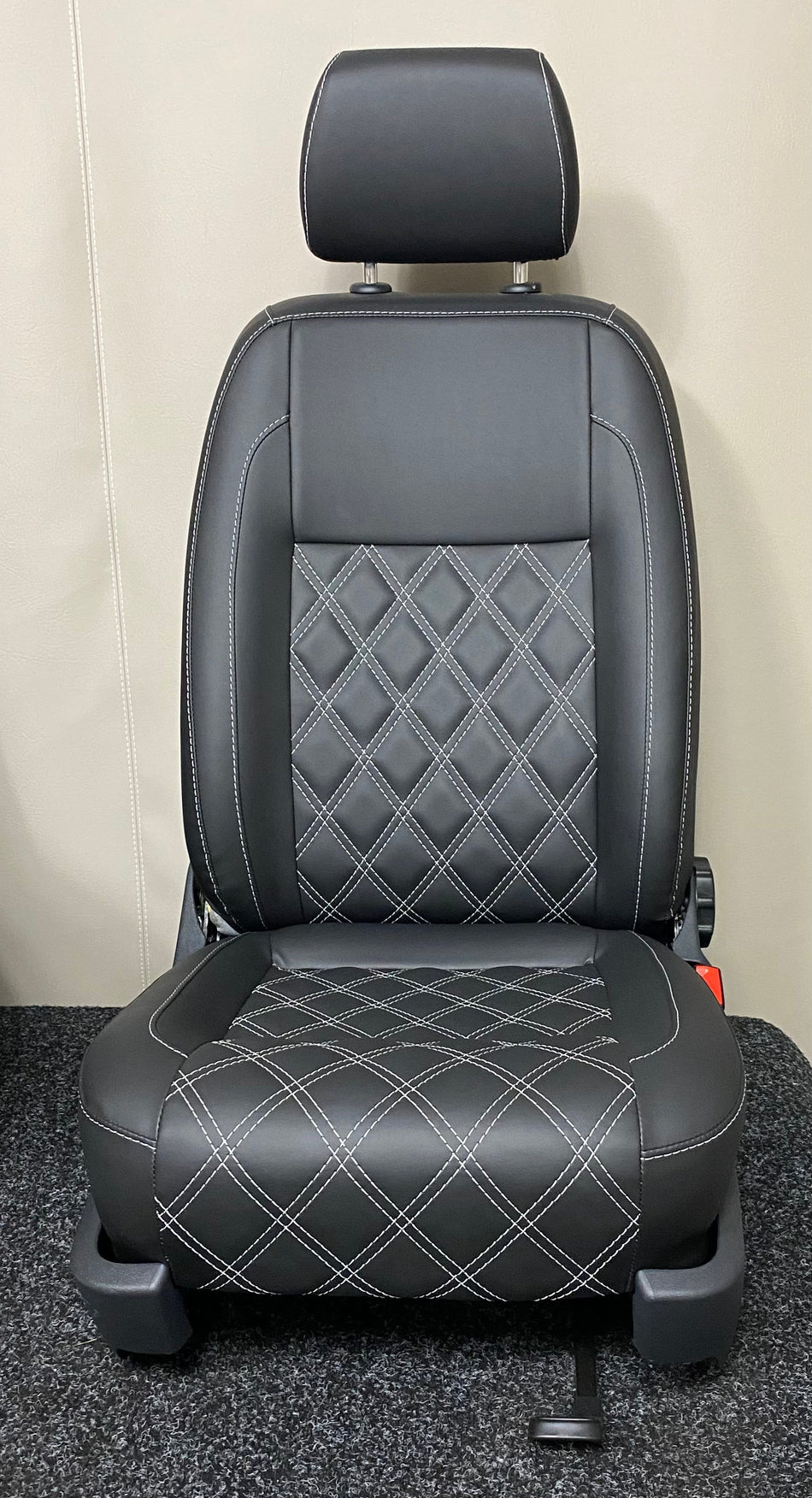VW Factory Driver Seat T5 T6 – front view of black leatherette seat with white Bentley full stitching and dark grey plastic trim.
