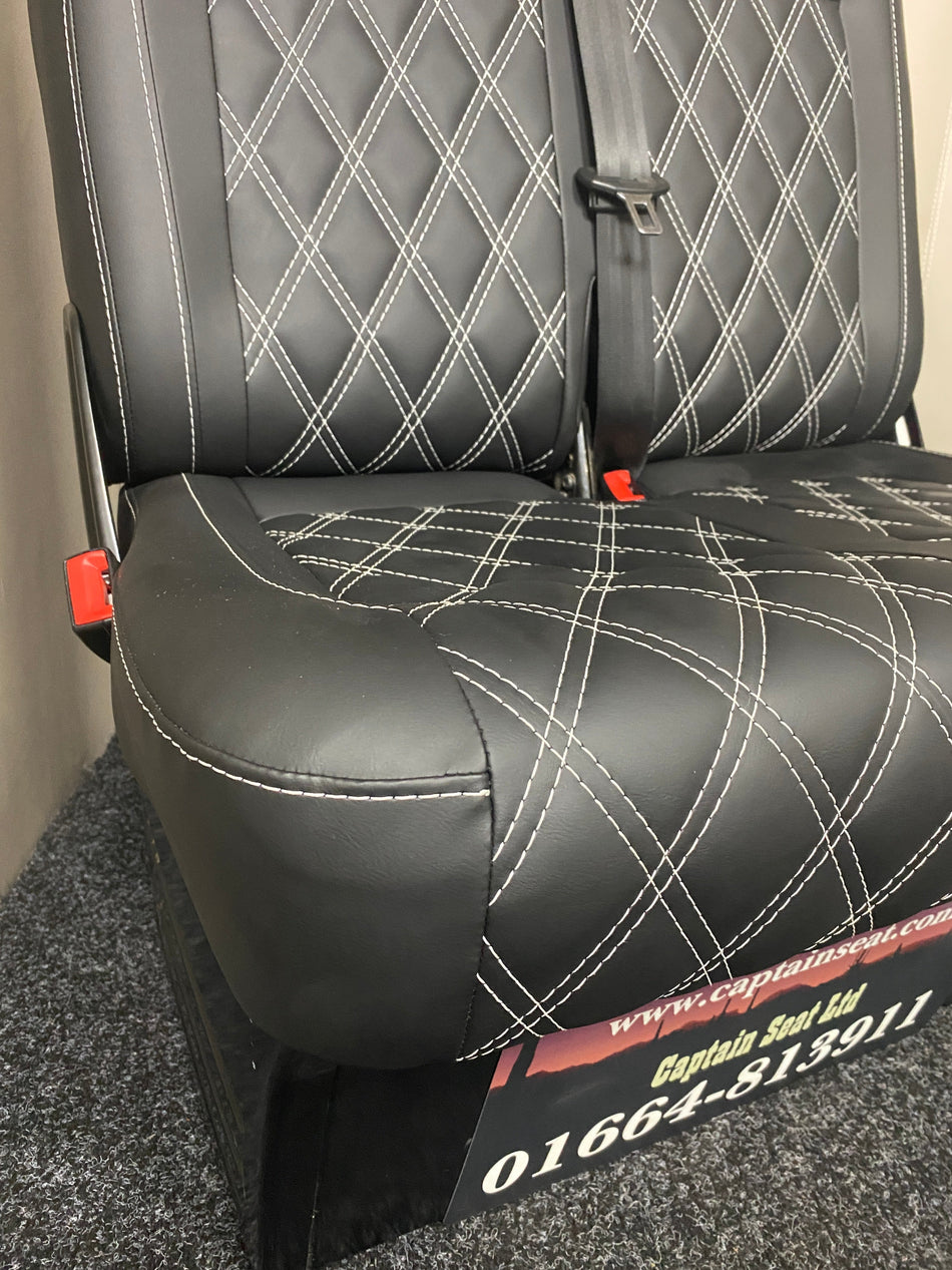 VW Factory T5 T6 double folding seat close-up, black leatherette with full Bentley cross stitching and dark grey plastic trim.
