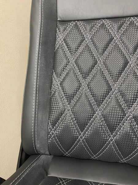 VW Factory T5 T6 seat close-up of   black real leather and carbon perforated centre panel with black Alcantara insert featuring light grey Bentley stitching.