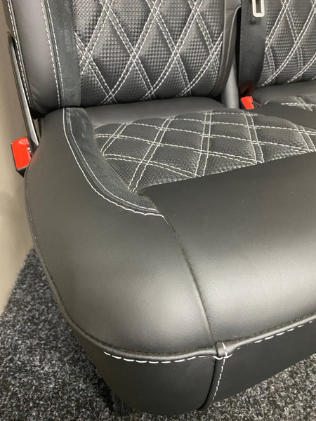 VW Factory T5 T6 seat base close-up of black real leather and carbon perforated centre panel, light grey Bentley stitching, and white leatherette piping.