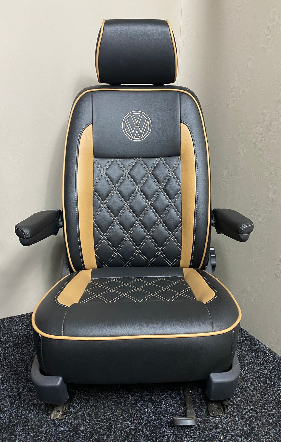 VW Factory T5 T6 Driver Seat, in black leatherette with toffee side inserts, armrests, cream VW logo and Bentley cross stitching.