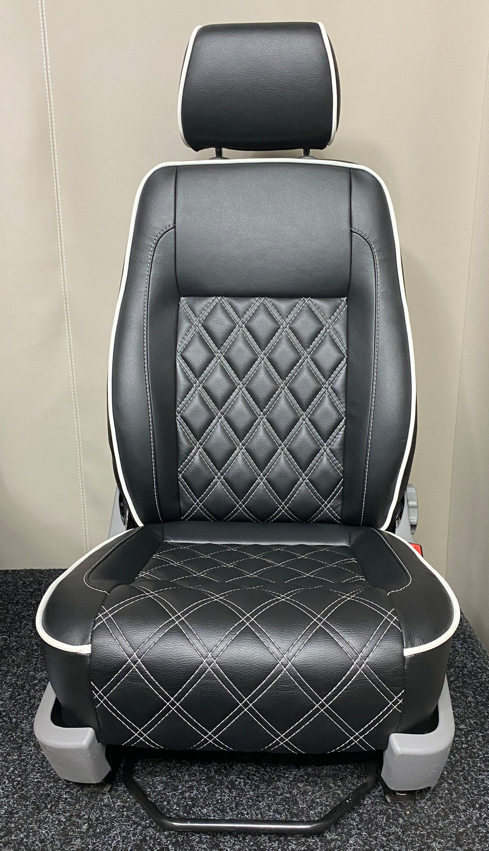 VW Factory T5 T6 driver seat in black leatherette with full Bentley cross-stitch pattern and white leatherette piping. Features light grey plastic trim.