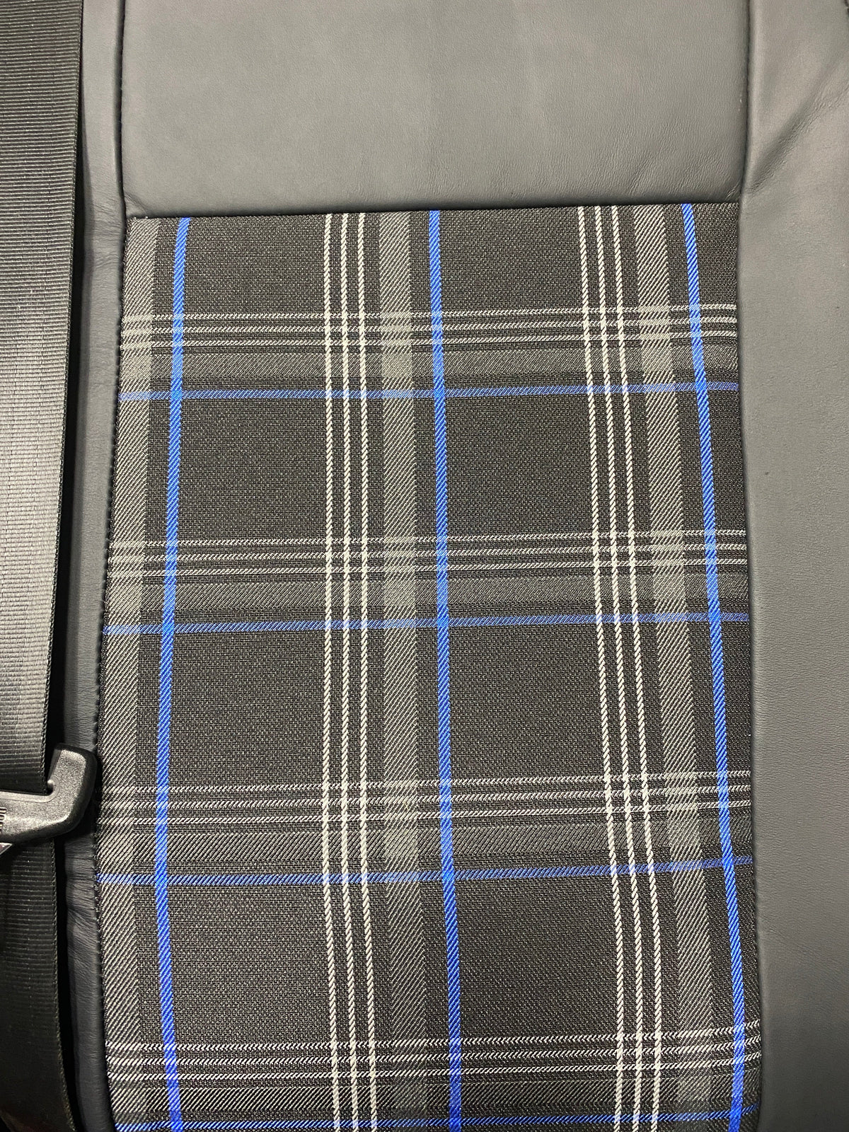 VW Factory T5 T6 Front Seat, close-up of black real leather and blue tartan centre panel.
