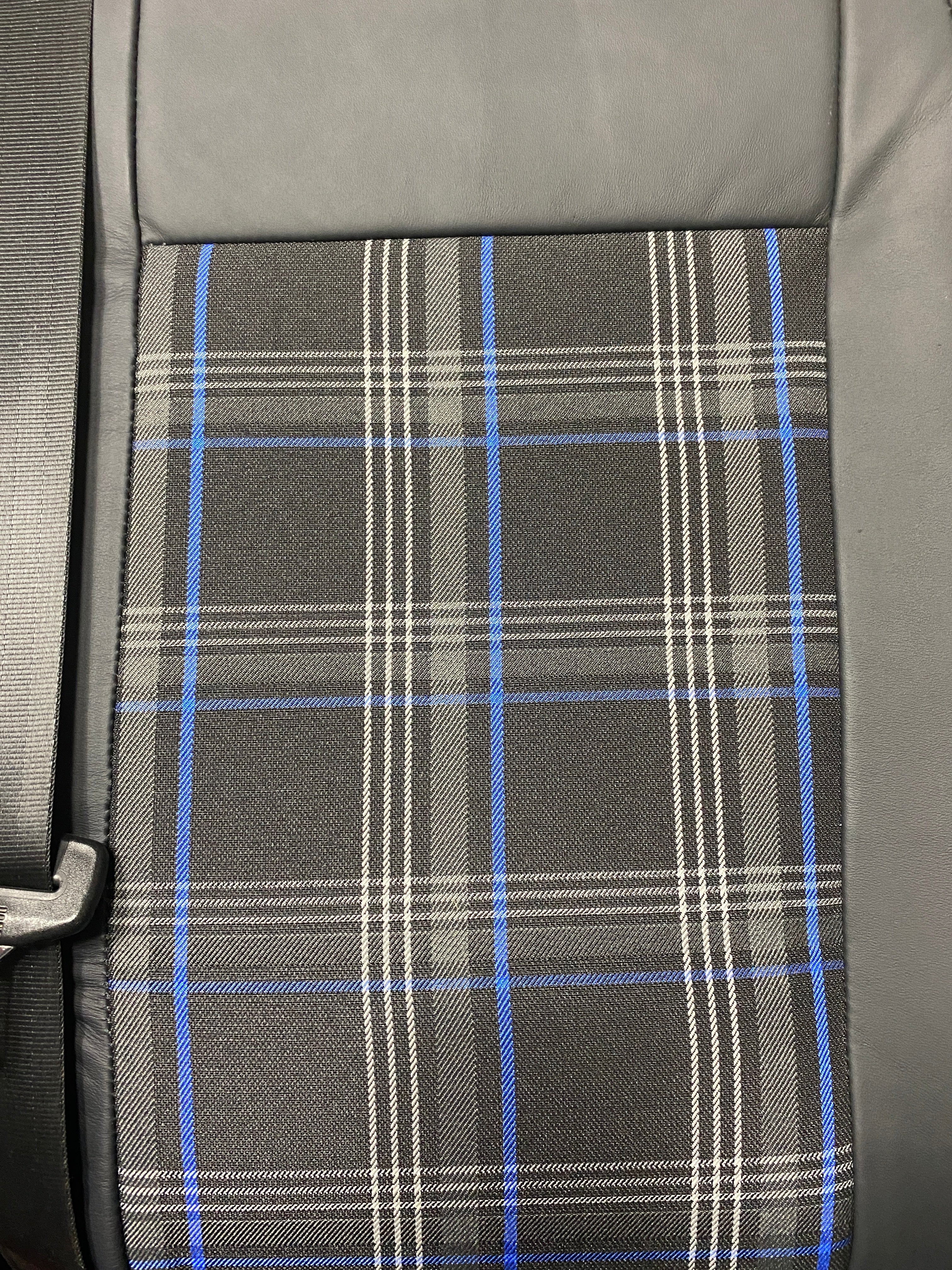 VW Factory T5 T6 Front Seat, close-up of black real leather and blue tartan centre panel.