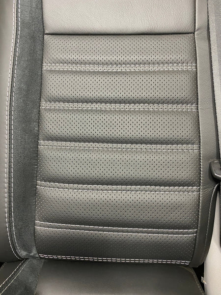 VW Factory T5 T6 seat close-up of black perforated centre panel with black horizontal wide cross-stitching and Alcantara faux suede insert.