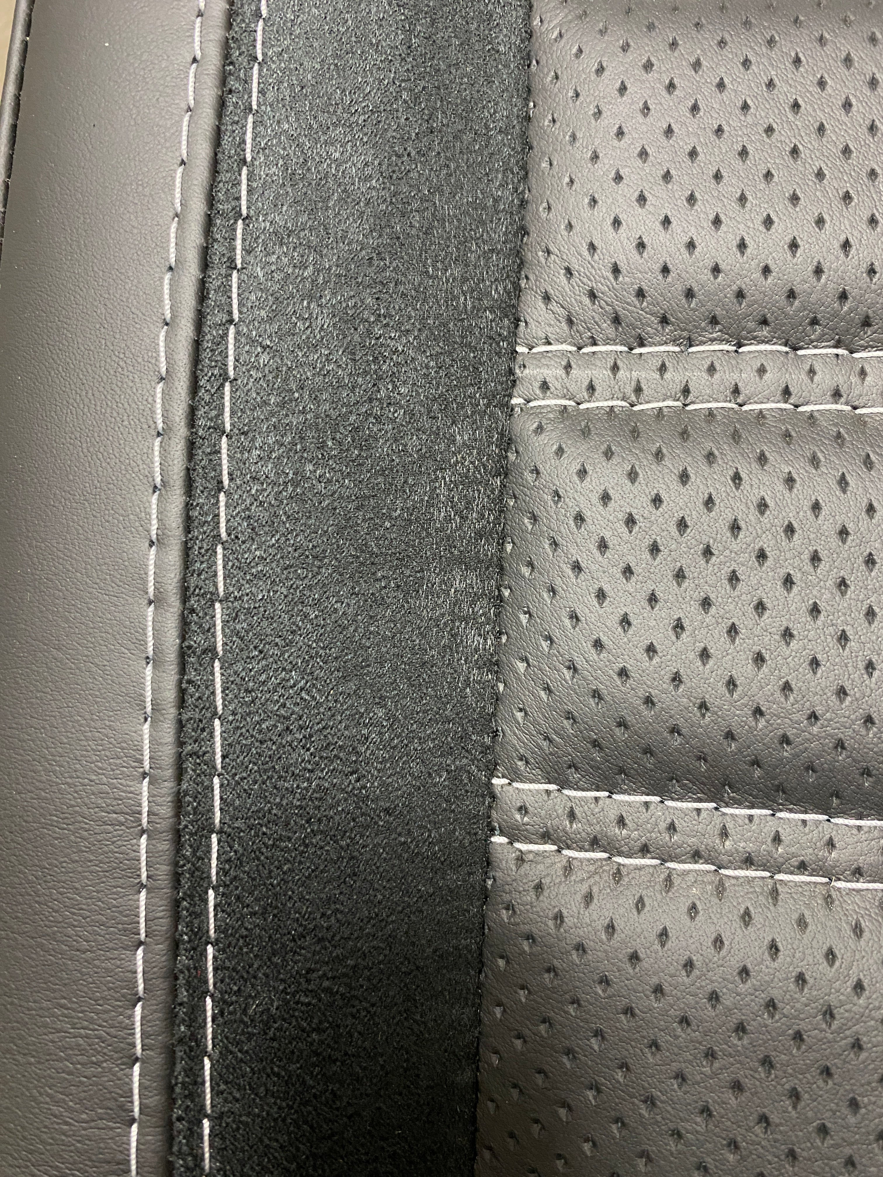 VW Factory T5 T6 seat close-up of Alcantara faux suede side insert and black perforated centre panel with horizontal wide cross-stitching.