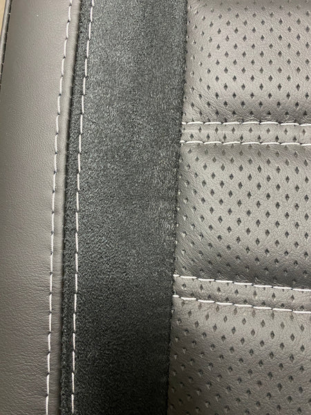 VW Factory T5 T6 seat close-up of Alcantara faux suede side insert and black perforated centre panel with horizontal wide cross-stitching.