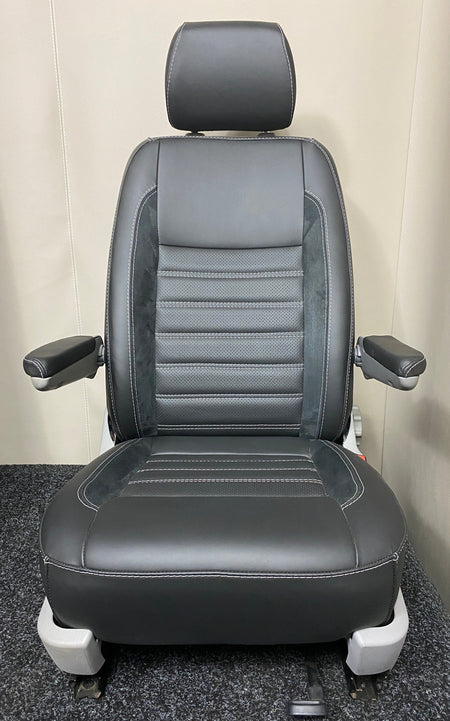 VW Factory T5 T6 driver seat in black real leather with perforated centre panel, Alcantara faux suede inserts, horizontal wide cross-stitching, and dual armrests.