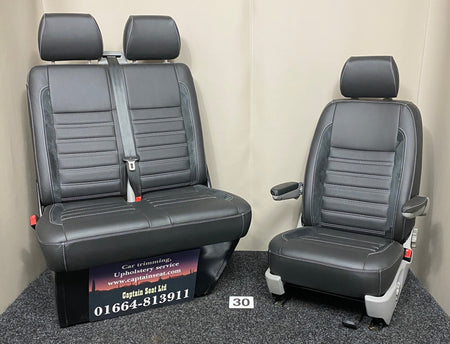 VW Factory T5 T6 front seats in black real leather with Alcantara faux suede inserts and perforated centre panels. Features black horizontal wide cross-stitching, and light grey plastic trim.