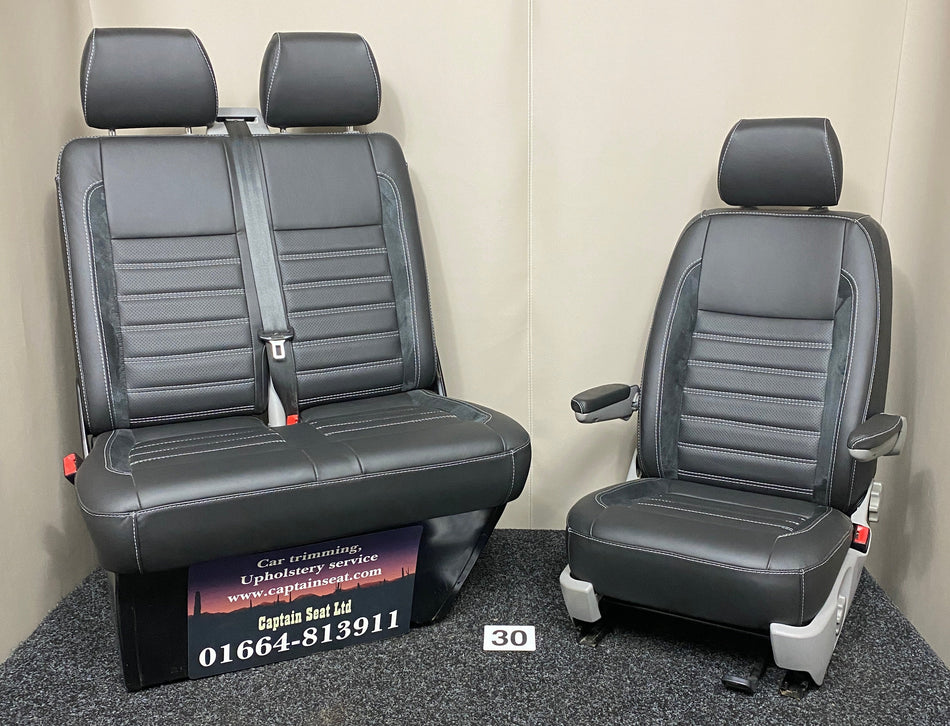 VW Factory T5 T6 front seats in black real leather with Alcantara faux suede inserts and perforated centre panels. Features black horizontal wide cross-stitching, and light grey plastic trim.