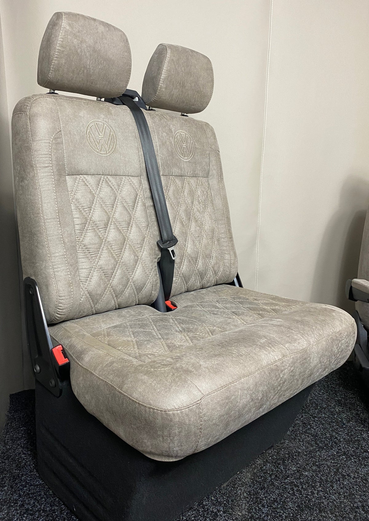 VW Factory T5 T6 Passenger Seats in beige faux suede with cream Bentley cross stitching and black VW logos on the upper backrests.