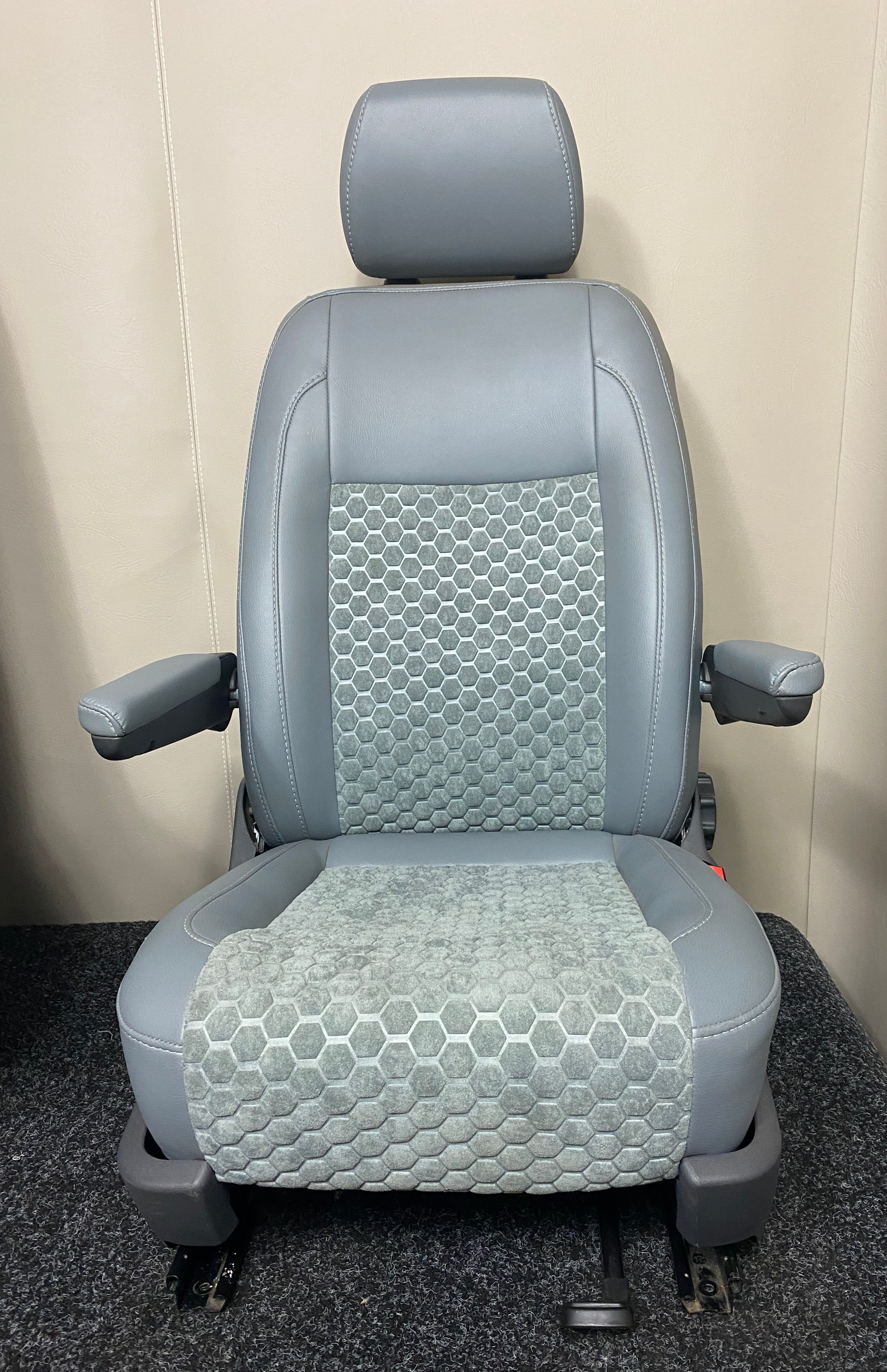 VW Factory T5 T6 driver seat in grey leatherette with a grey fabric honeycomb centre panel and grey stitching. Features dual armrests and dark grey plastic trim.