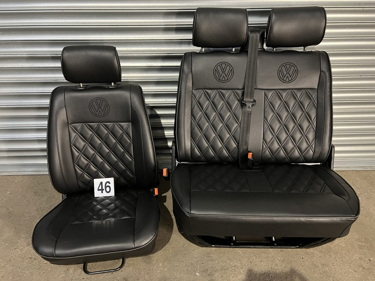 VW T4 front seats, front view showing black leatherette with black Bentley pattern, piping detail, and VW logo on headrests.