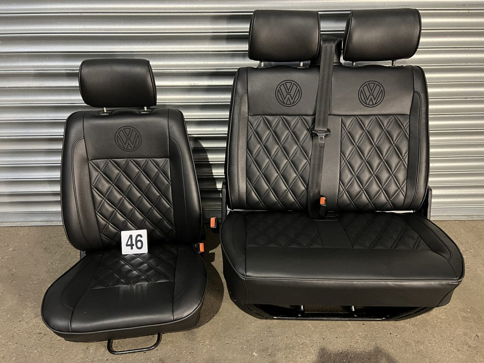 VW T4 front seats, front view showing black leatherette with black Bentley pattern, piping detail, and VW logo on headrests.