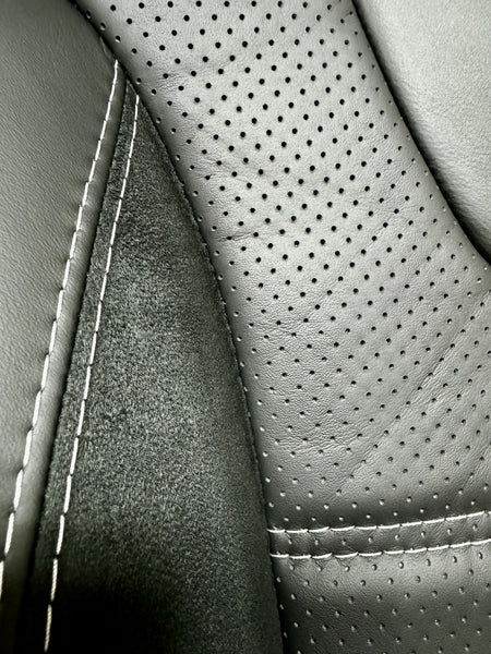 Close-up of VW T5 T6 Factory Front Seat Wing Back showing perforated leather centre panel, Alcantara inserts, and light grey stitching.