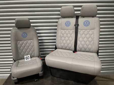 VW T5 T6 front seats in light grey leatherette with royal blue Bentley stitch pattern and VW logos.