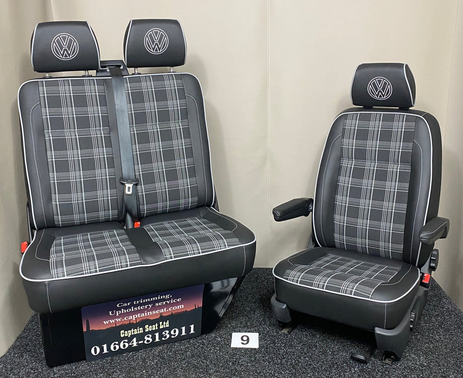 VW T5 T6 front seats, full front view showing black leatherette with grey Tartan centre panels, light grey piping, and VW logo on headrests.